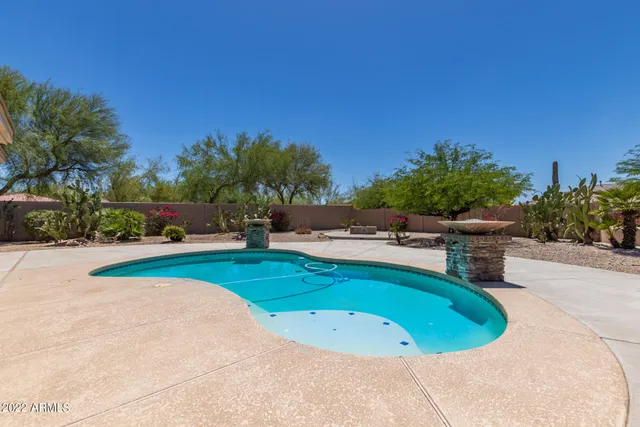 a view of a swimming pool and lounge chairs