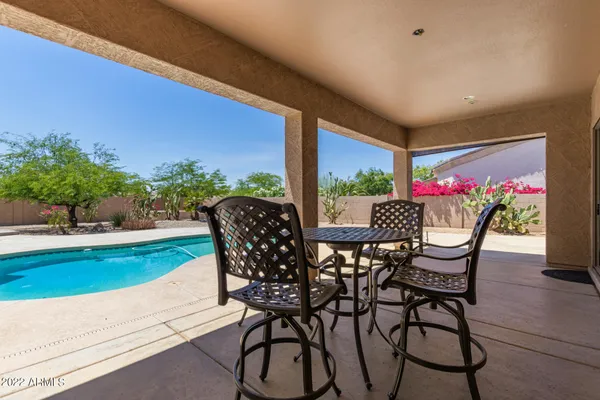 a view of a swimming pool with an outdoor seating