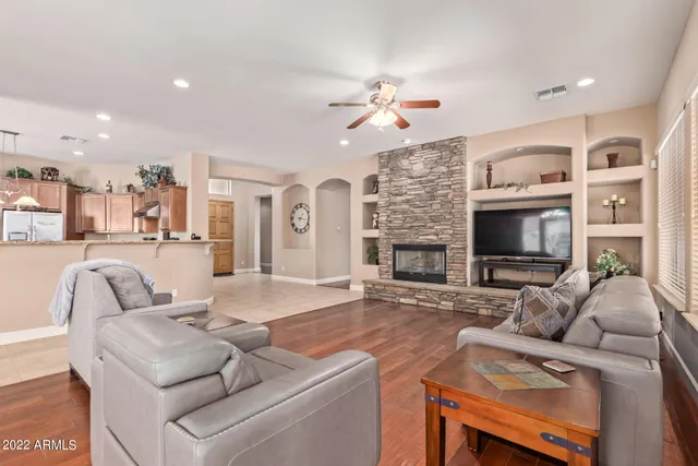 a living room with furniture a fireplace and a flat screen tv