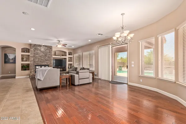 a living room with furniture and a chandelier