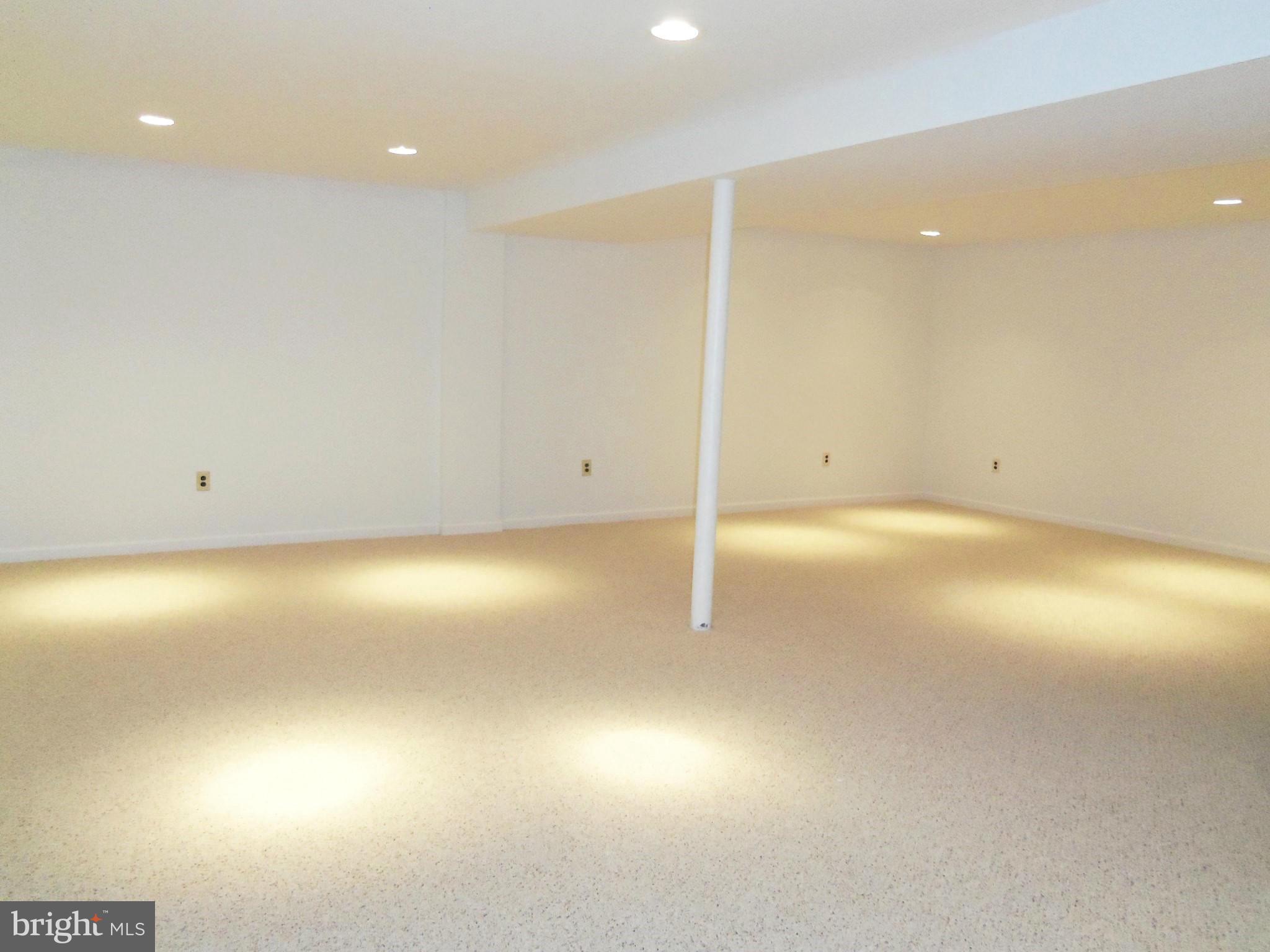 1920 Brookdale Road Baltimore, MD 21244 - Photo 13 of 22 an empty room with a ceiling fan and windows