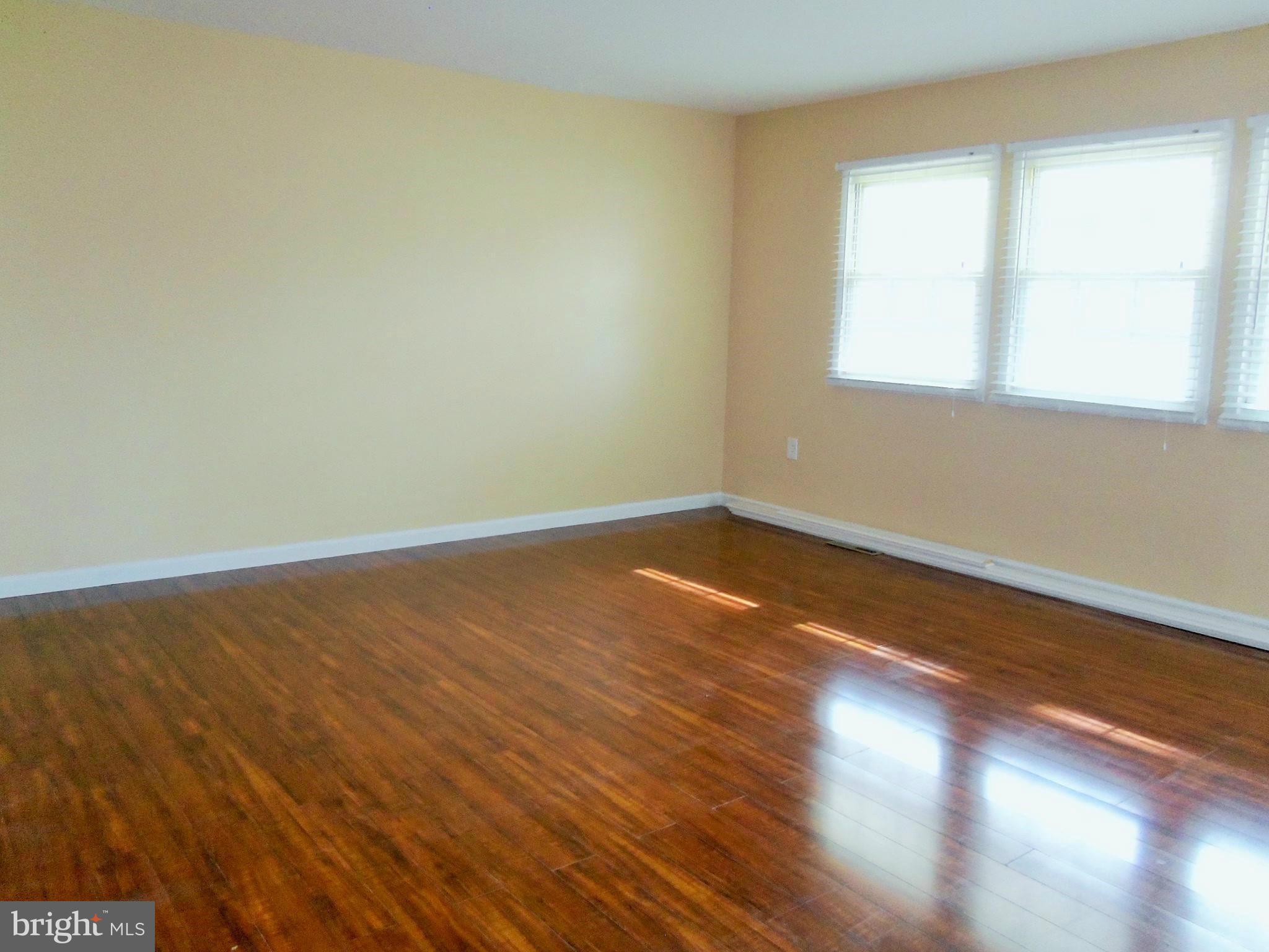 1920 Brookdale Road Baltimore, MD 21244 - Photo 3 of 22 a view of a room with wooden floor and a window