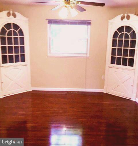 1920 Brookdale Road Baltimore, MD 21244 - Photo 5 of 22 an empty room with wooden floor and windows