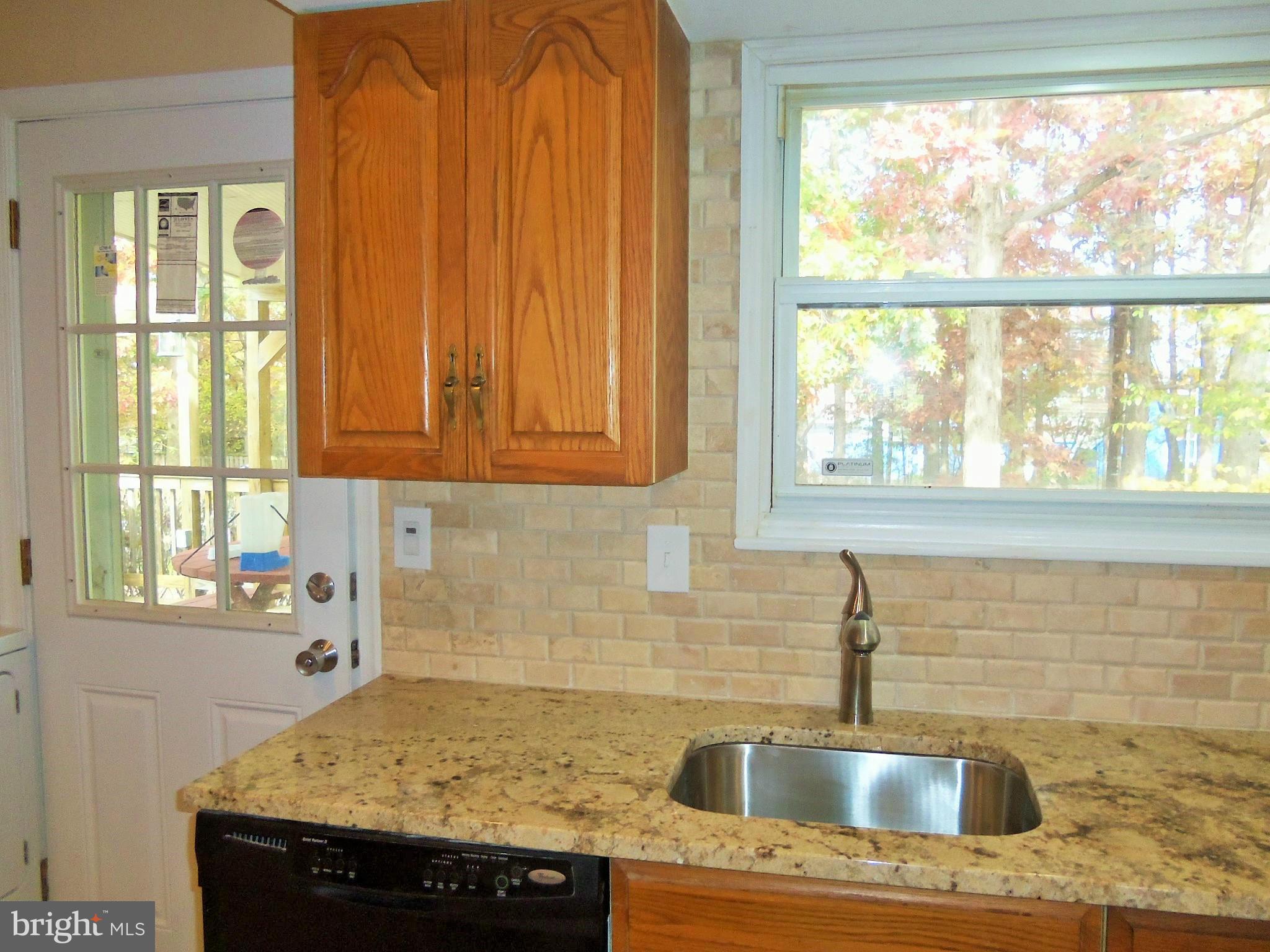 1920 Brookdale Road Baltimore, MD 21244 - Photo 7 of 22 a kitchen with granite countertop sink and window