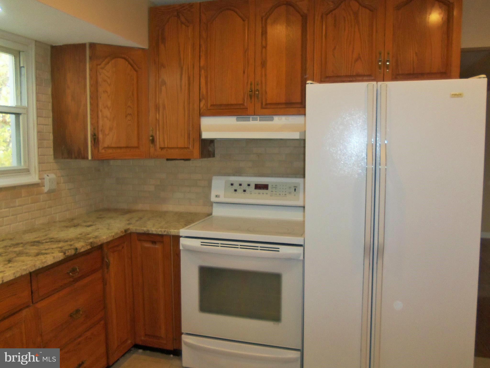 1920 Brookdale Road Baltimore, MD 21244 - Photo 10 of 22 a kitchen with a stove top oven sink and cabinets