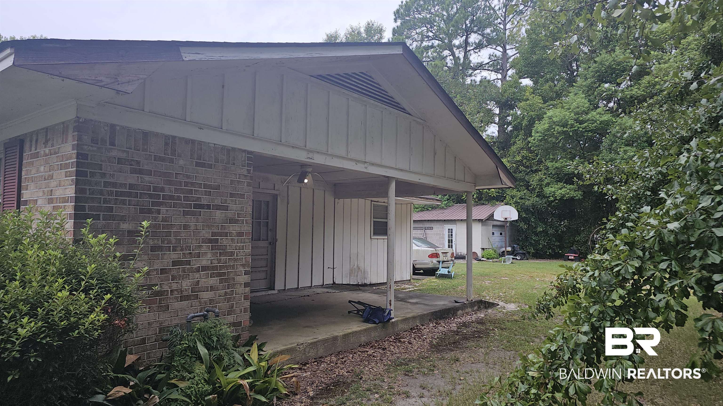 216 6th Avenue Atmore, AL 36502 - Photo 20 of 34 View of home's exterior featuring a yard and a garage
