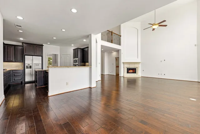 a view of a living room kitchen with furniture and wooden floor