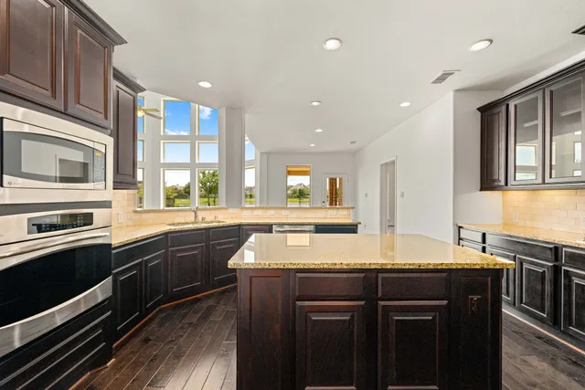 a kitchen with a sink stove and microwave