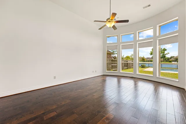 a view of room with wooden floor and fan