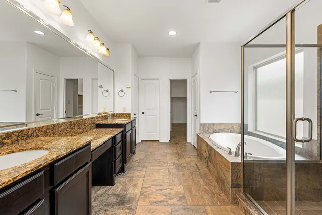 a large kitchen with a counter space a sink and stainless steel appliances
