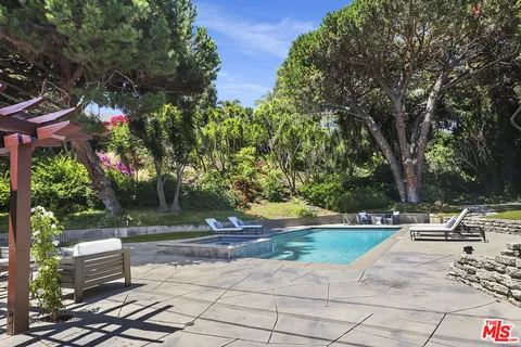 a view of backyard with outdoor seating and trees