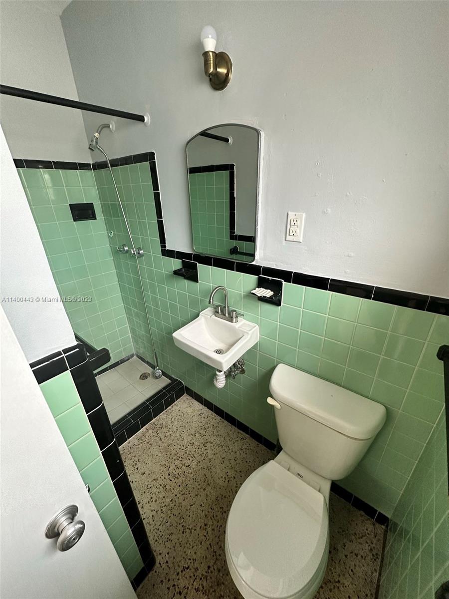 West Flagler Miami, FL 33125 - Photo 11 of 14 a bathroom with a toilet sink and mirror