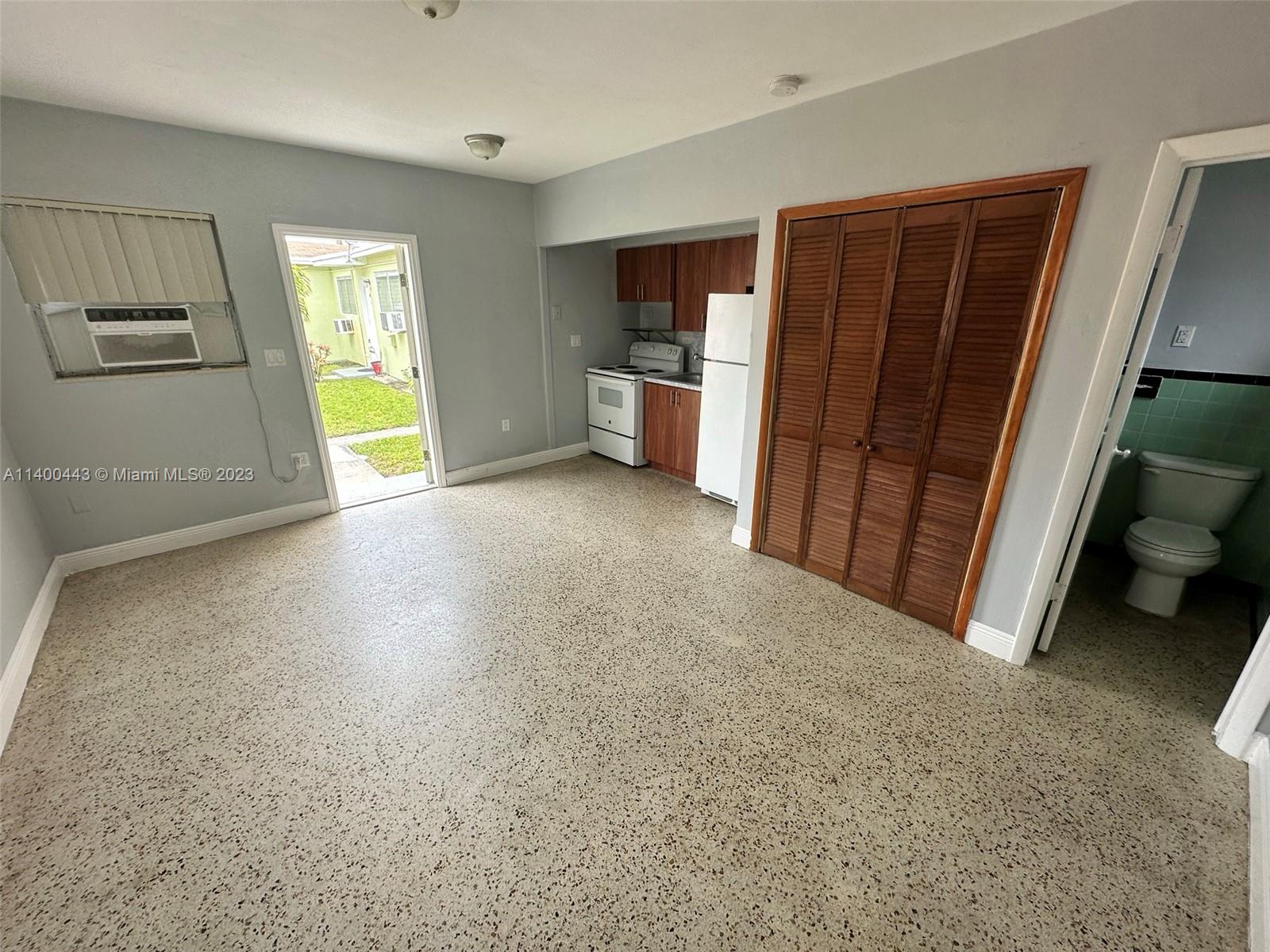 West Flagler Miami, FL 33125 - Photo 13 of 14 a view of a kitchen with furniture and a refrigerator