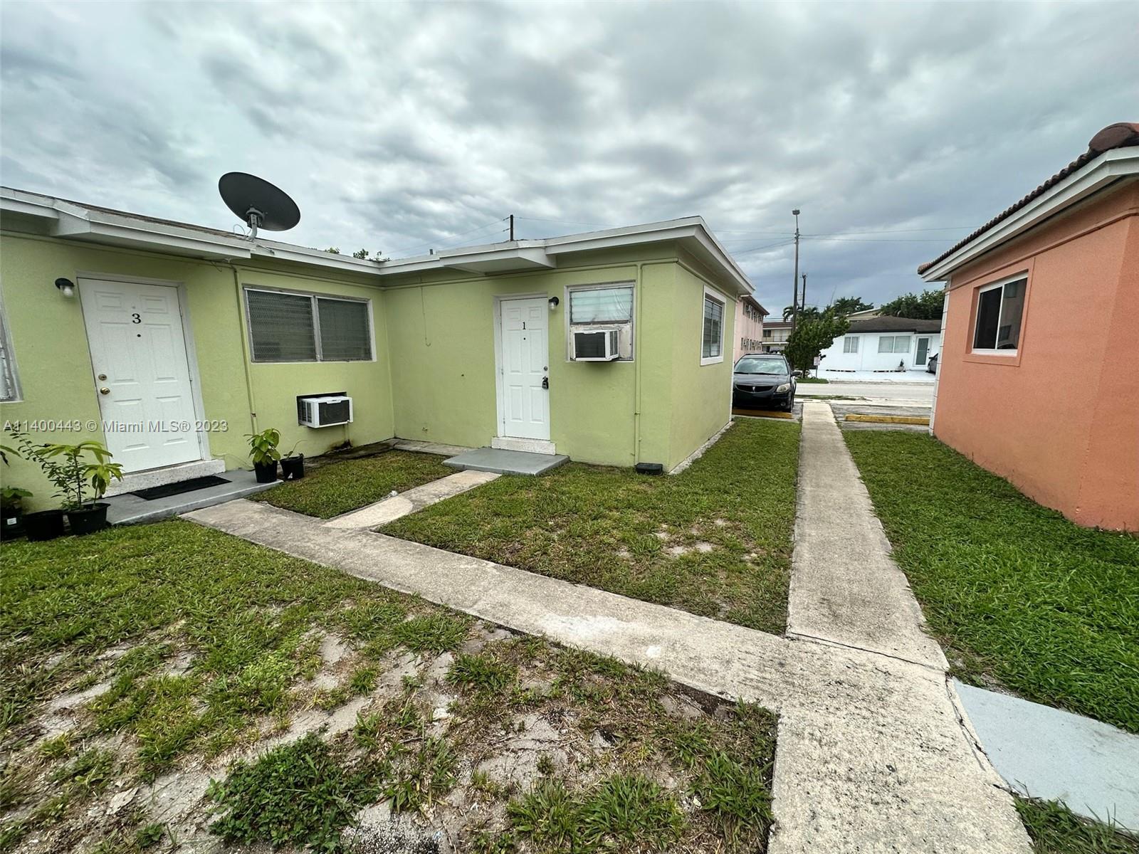West Flagler Miami, FL 33125 - Photo 2 of 14 a front view of a house with a yard