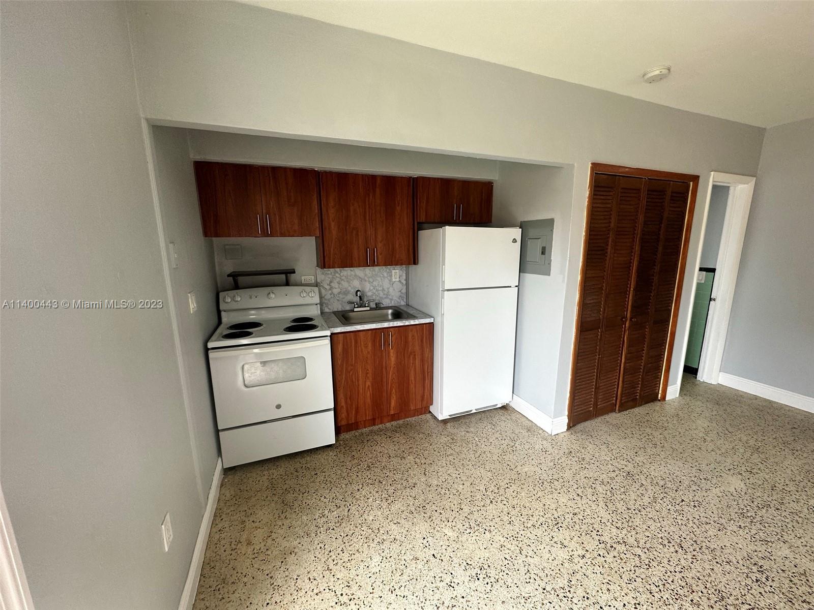 West Flagler Miami, FL 33125 - Photo 3 of 14 a kitchen with a refrigerator sink stove and cabinets