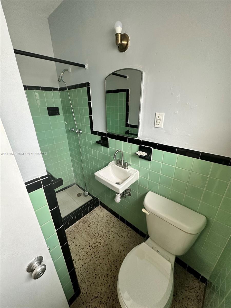 West Flagler Miami, FL 33125 - Photo 5 of 14 a bathroom with a toilet sink and mirror