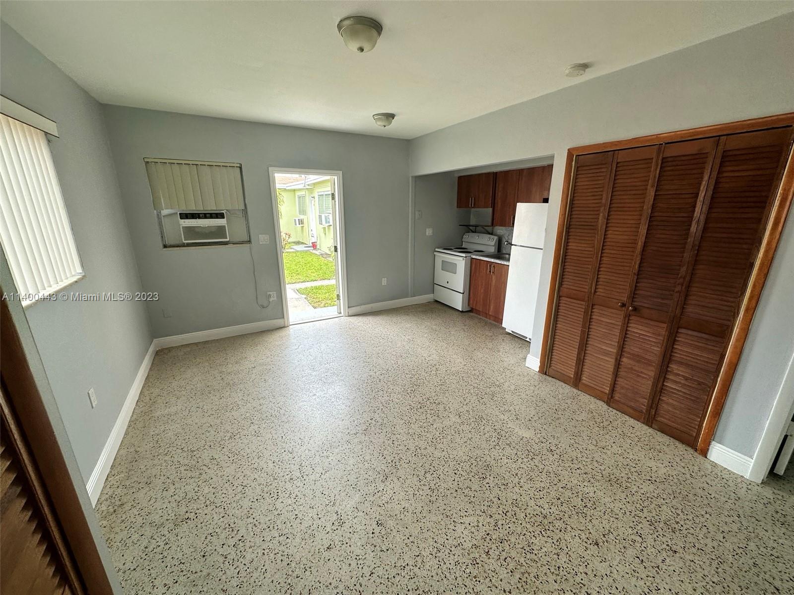 West Flagler Miami, FL 33125 - Photo 8 of 14 wooden floor in an empty room with a window