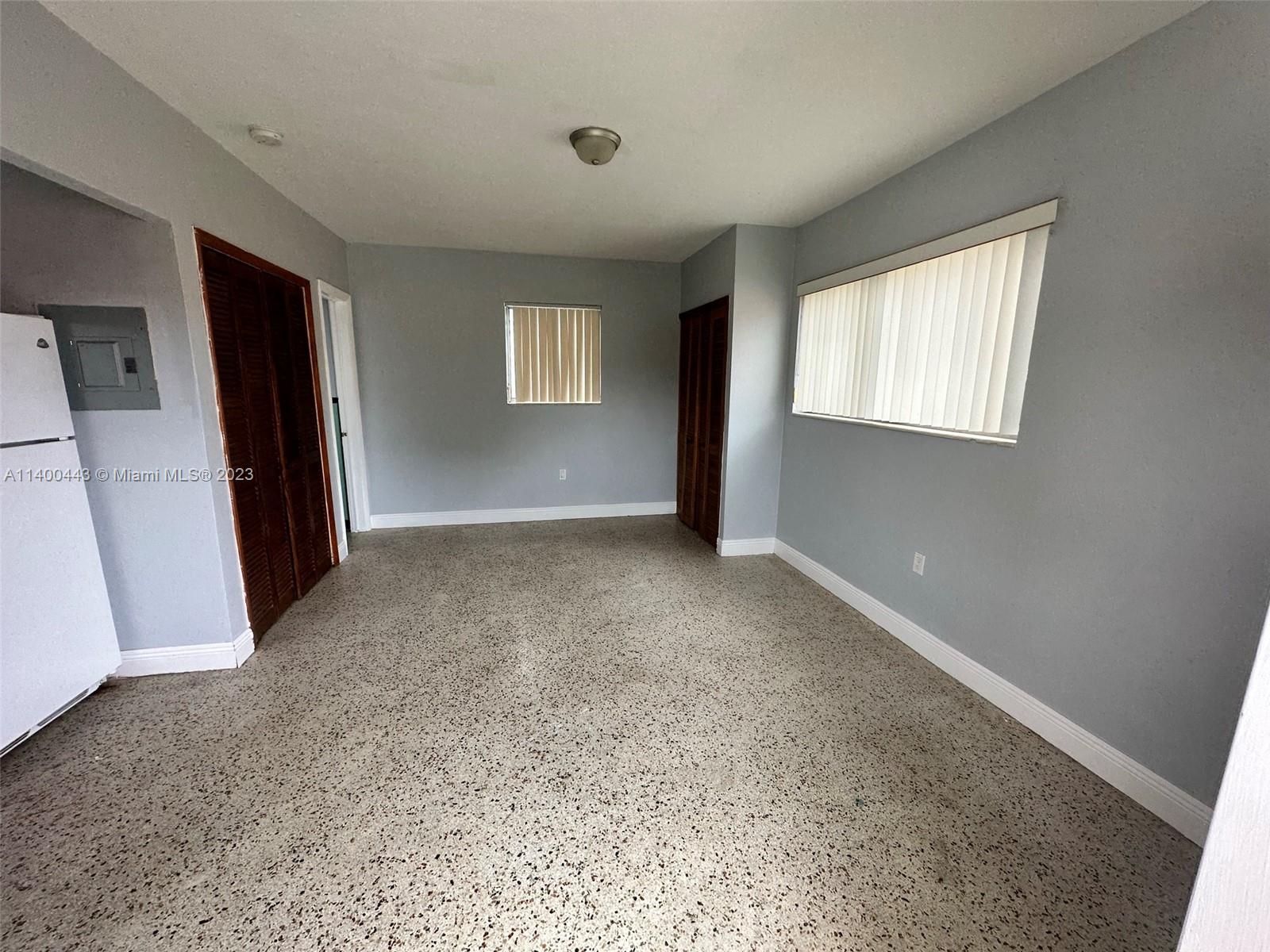 West Flagler Miami, FL 33125 - Photo 9 of 14 an empty room with windows and closet