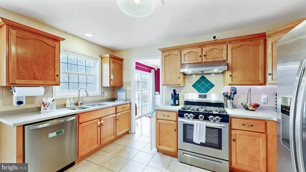 a kitchen with stainless steel appliances a sink stove and cabinets