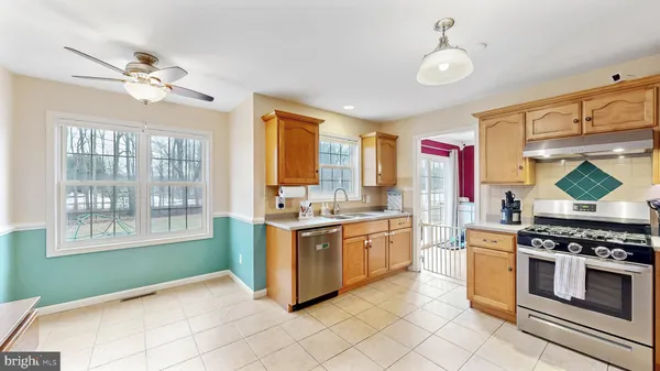 a kitchen with stainless steel appliances granite countertop a stove and a sink
