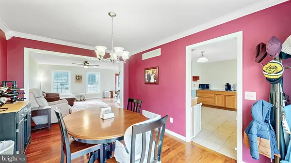 a view of a dining room with furniture and chandelier