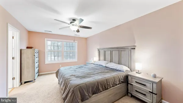 a spacious bedroom with a bed and a window