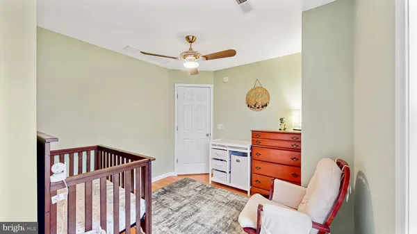 a bedroom with furniture and wooden floor