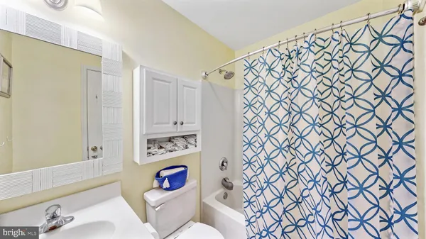 a white toilet sitting next to a bathroom sink
