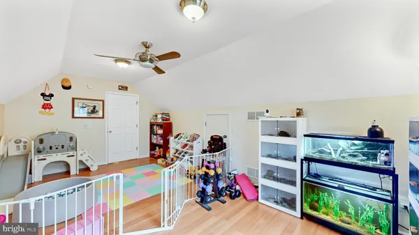 a bedroom with furniture a baby crib and a dresser