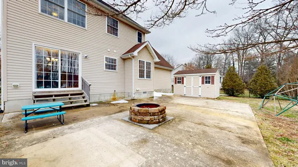 a backyard of a house with table and chairs