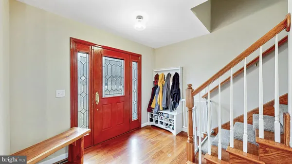 a view of an entryway with wooden floor and door