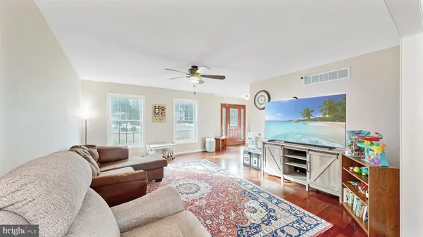 a living room with furniture fireplace and flat screen tv