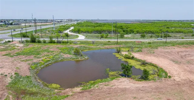 an aerial view of a golf course with a lake view