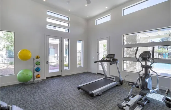 a room with gym equipment and a large window