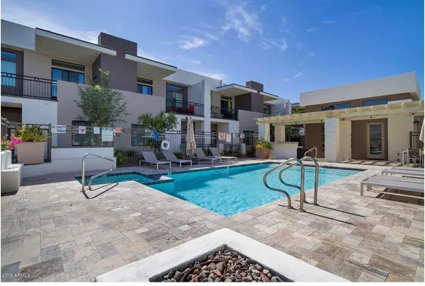 a view of a house with backyard and sitting area