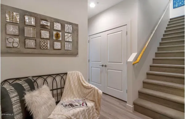 a view of a bedroom with wooden floor and stairs