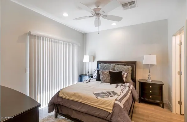a bedroom with a bed and a chandelier