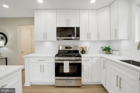 a bedroom with a bed and a wall painting with wooden floor