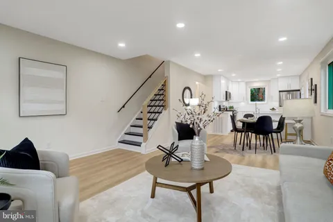 a living room with furniture and a lamp