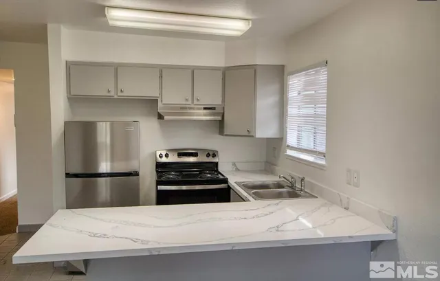 a kitchen with a sink appliances and cabinets