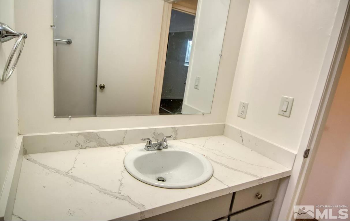 1446 Model Way, Unit 5 Reno, NV 89502 - Photo 9 of 9 a bathroom with a sink and a mirror