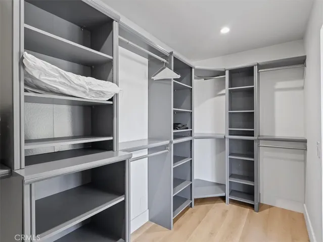 a bedroom with a bed and large window