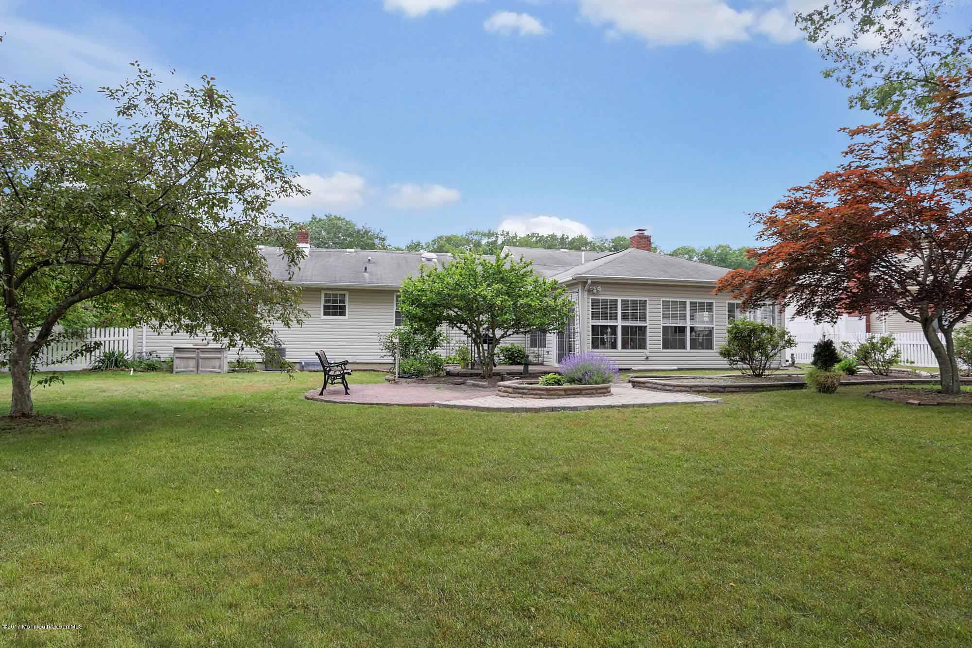 67 Newbury Road Howell, NJ 07731 - Photo 8 of 31 a front view of a house with a garden