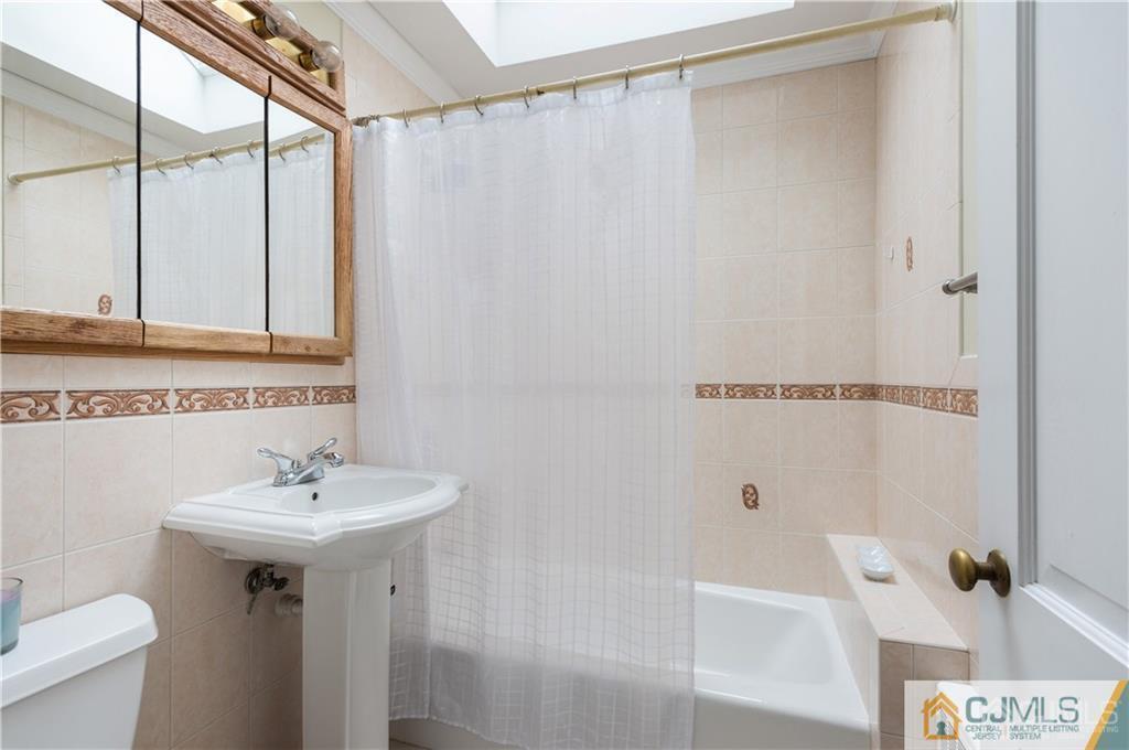 555 Chain O' Hills Road Colonia, NJ 07067 - Photo 12 of 18 a bathroom with a sink a bath tub and a shower