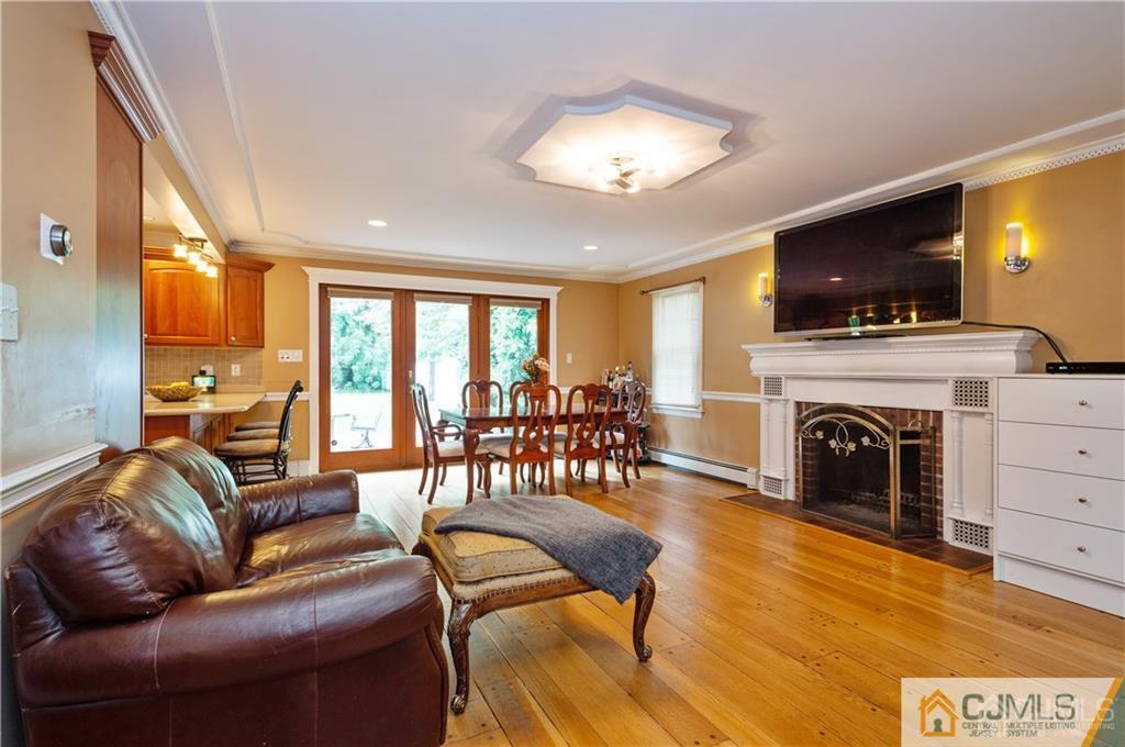 555 Chain O' Hills Road Colonia, NJ 07067 - Photo 5 of 18 a living room with furniture a flat screen tv and a fireplace