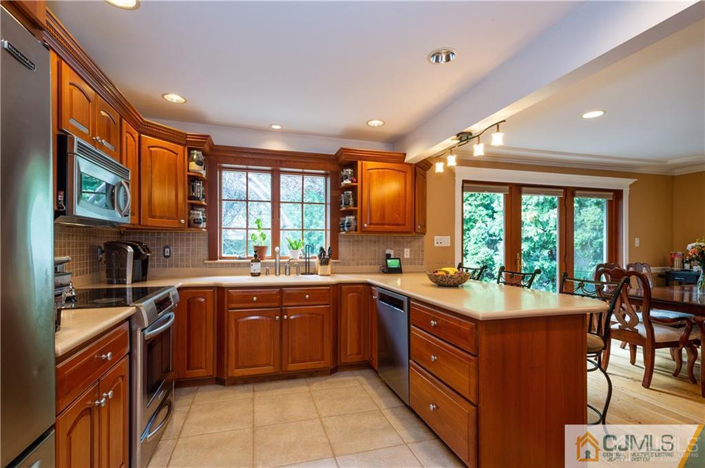 555 Chain O' Hills Road Colonia, NJ 07067 - Photo 7 of 18 a kitchen with a sink stove and cabinets