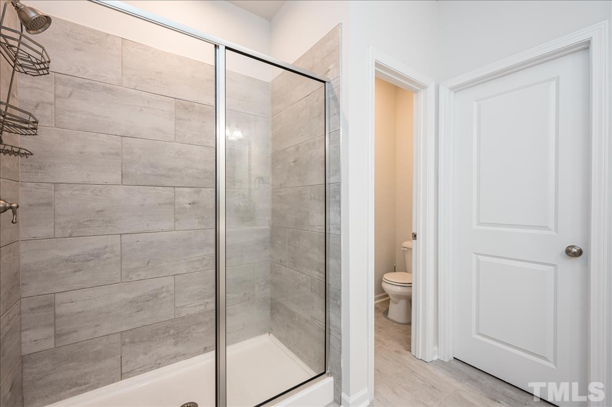 3620 Buffaloe Road Raleigh, NC 27604 - Photo 12 of 18 a bathroom with a glass shower door