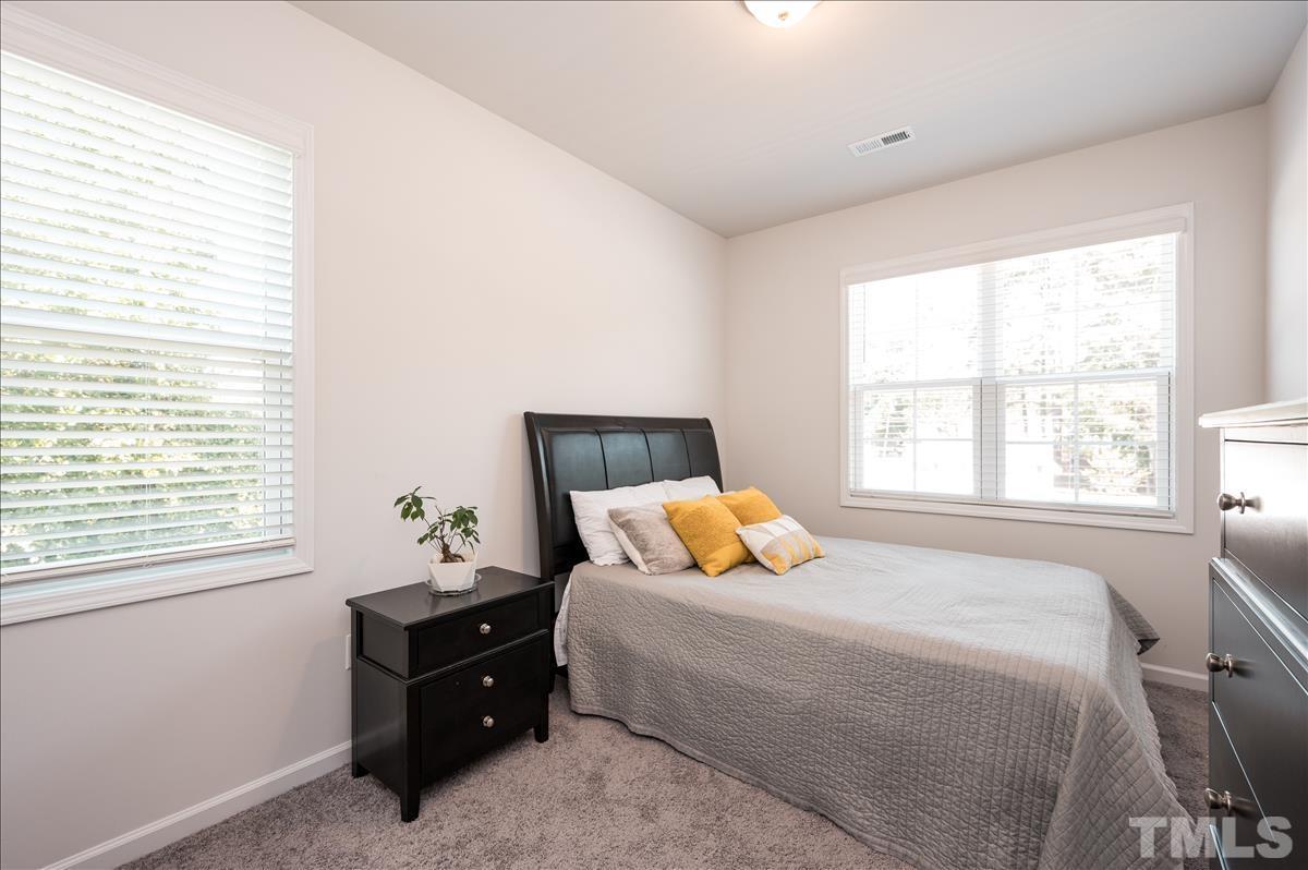 3620 Buffaloe Road Raleigh, NC 27604 - Photo 13 of 18 a bedroom with a bed and window