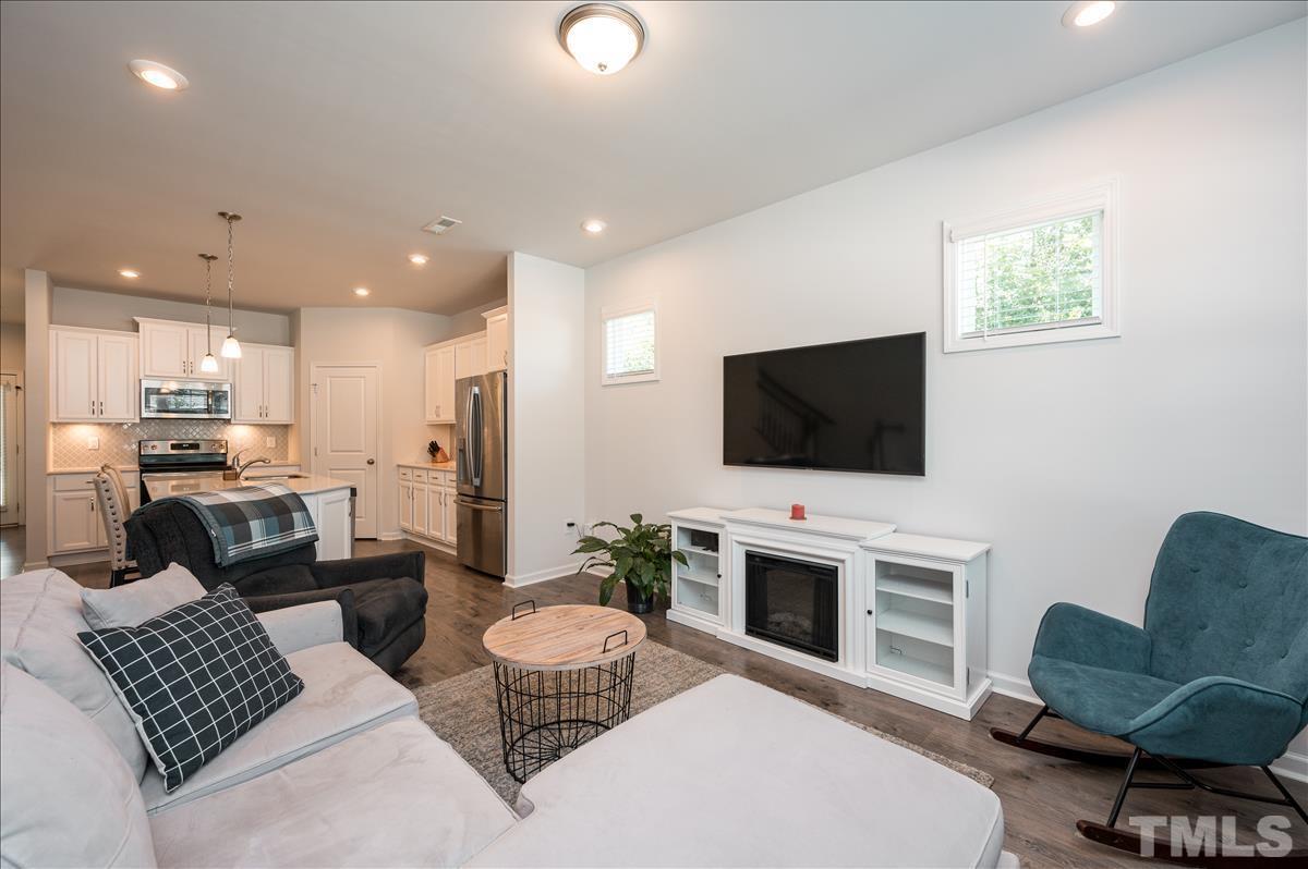 3620 Buffaloe Road Raleigh, NC 27604 - Photo 5 of 18 a living room with furniture a flat screen tv and kitchen view