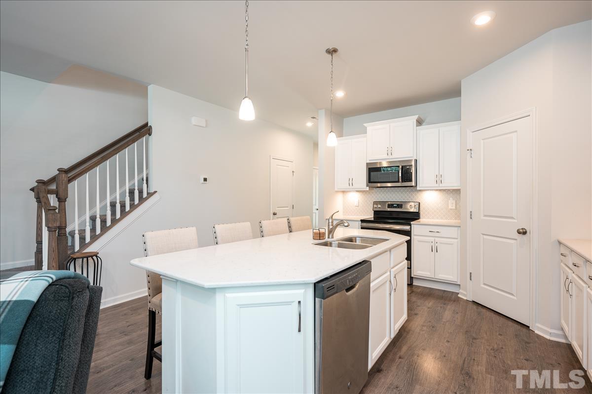 3620 Buffaloe Road Raleigh, NC 27604 - Photo 6 of 18 a kitchen that has a lot of white cabinets and stainless steel appliances